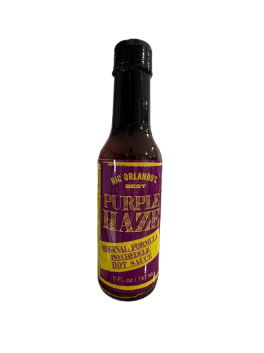 Purple Haze hot sauce bottle on black background.